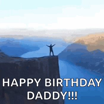 a man is standing on top of a cliff overlooking a body of water .