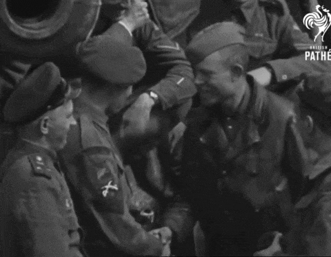 a group of soldiers are shaking hands and the word pathe is on the bottom right
