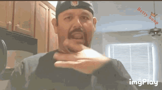 a man wearing a hat with the nfl logo on it looks at the camera