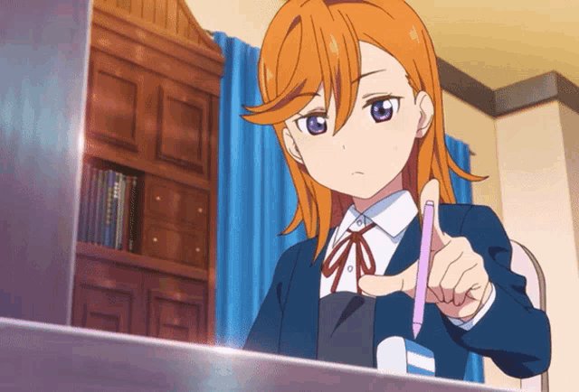 a girl with orange hair is pointing at something