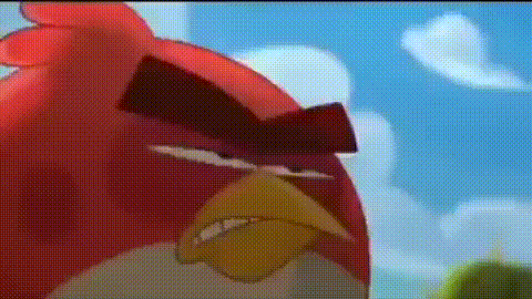 a close up of a red angry bird with a yellow beak making a funny face .