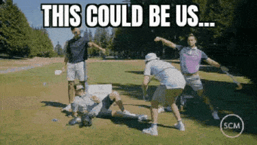 a group of men are playing golf on a golf course and one of them is laying on the grass .