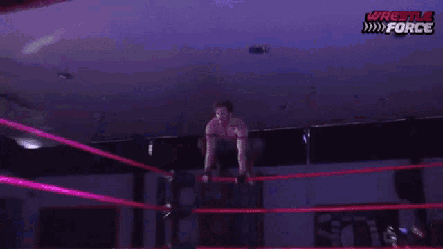 a wrestler is falling through the air in a wrestling ring with the words wrestle force on the bottom