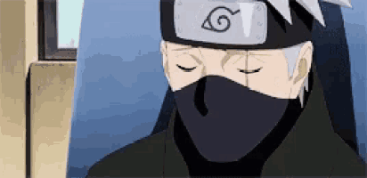 a man wearing a mask and headband is sitting in a chair .