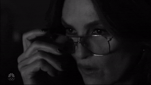a black and white photo of a woman wearing glasses with the nbc logo on the bottom