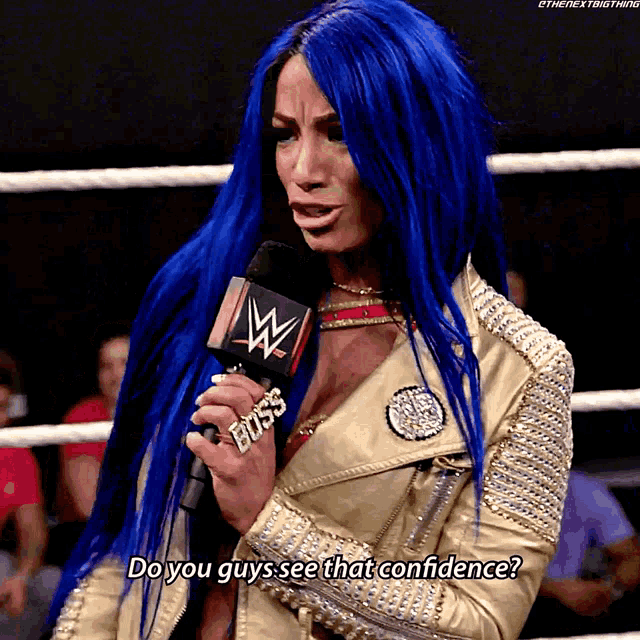 a woman with blue hair is holding a microphone that says boss