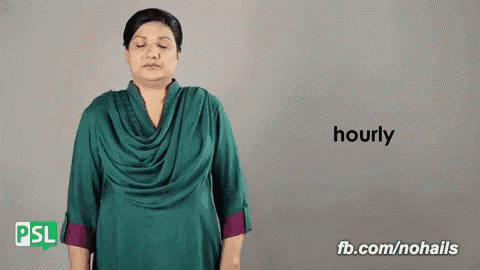 a woman in a green dress is making a hand gesture that says hourly