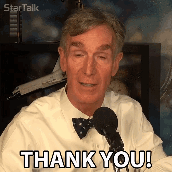 a man with a bow tie says thank you in front of a microphone