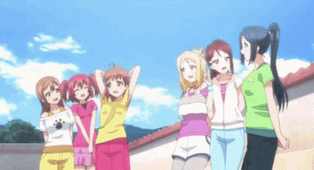a group of anime girls standing next to each other with one wearing a yellow shirt with the number 2