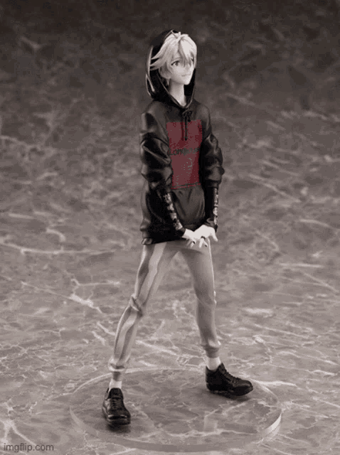 a black and white statue of a boy wearing a black hoodie with a red logo on the front