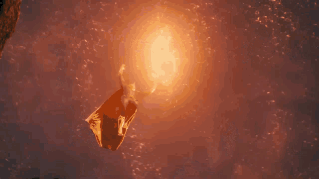 a person is flying through a cloud of fire in the sky .