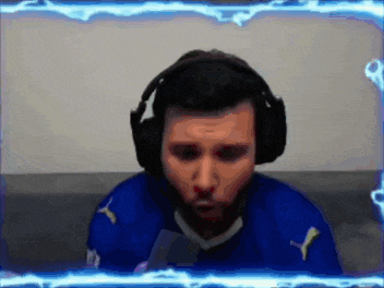 a man wearing headphones and a blue shirt with a puma logo