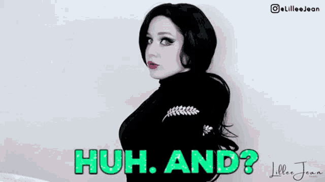 a woman in a black dress is standing in front of a white wall and says huh and ?