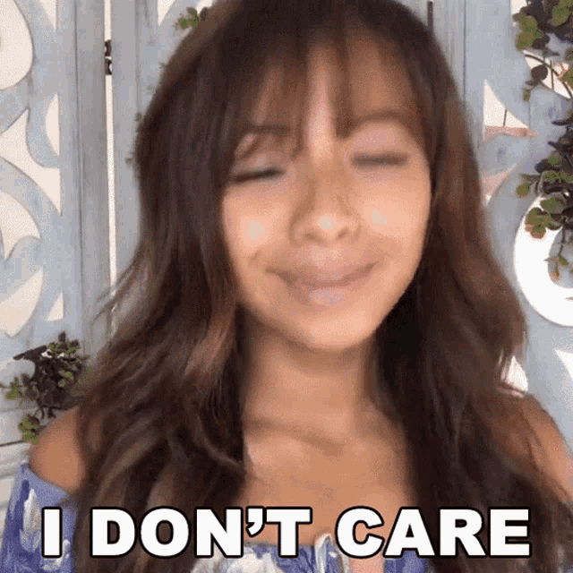 a woman says i don 't care while smiling with her eyes closed