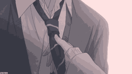 a man in a suit and tie adjusts his tie