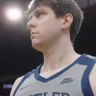 a close up of a basketball player wearing a jersey that says ucla