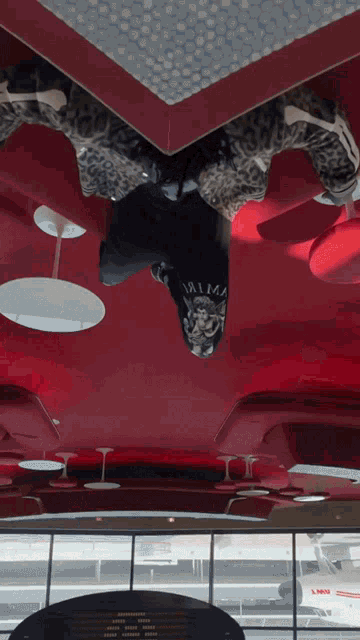 a person wearing a black shirt with the word palma on it is upside down