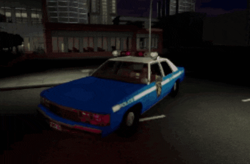 a blue police car is parked in a parking lot