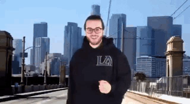 a man wearing a black hoodie with the letter la on it
