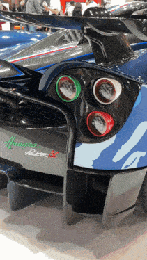 a blue and black sports car with the word huayra on the back