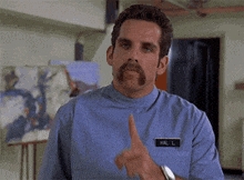 a man with a mustache and a name tag that says mr. l.