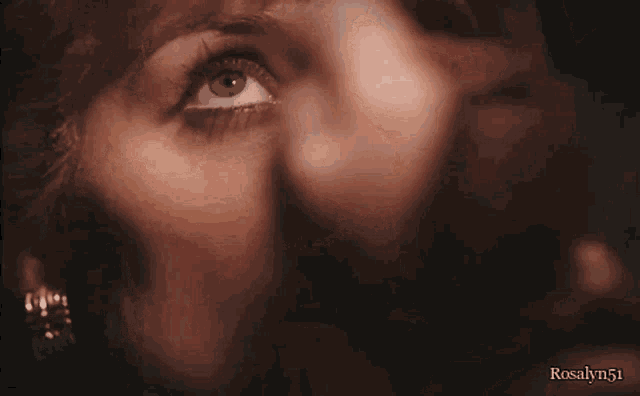 a close up of a woman 's face with rosalyn51 on the bottom right