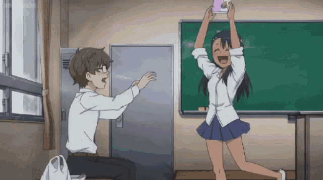 a boy and a girl are in a classroom and the girl is holding a book over her head