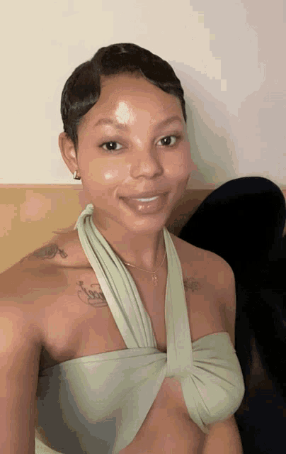 a woman with a tattoo on her shoulder that says ' love '