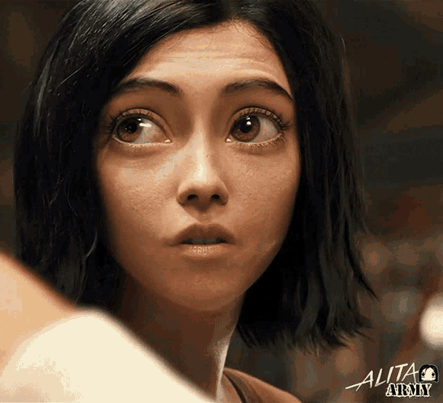 a close up of a woman 's face with the word alita army on the bottom right
