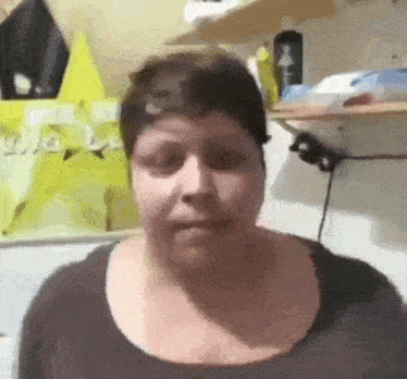 a woman is making a funny face in a kitchen .