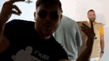 a man wearing sunglasses and a t-shirt that says gkib on it