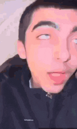 a close up of a young man 's face with his eyes closed