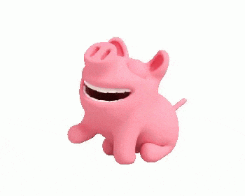 a pink pig is sitting down and smiling with its mouth open .