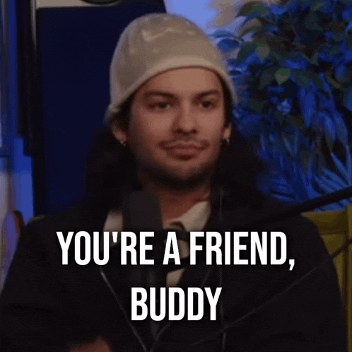 a man talking into a microphone with the words you 're a friend buddy