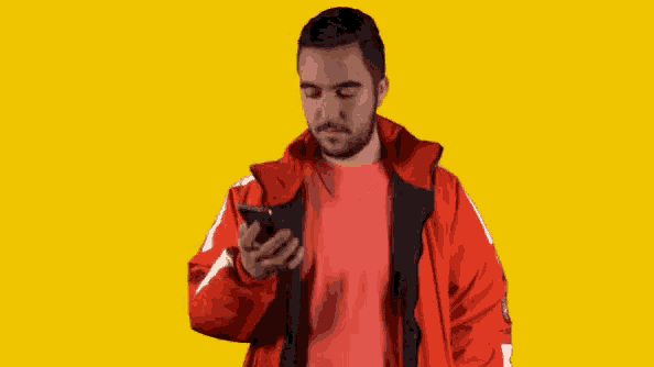 a man wearing a red jacket with the letter s on the front