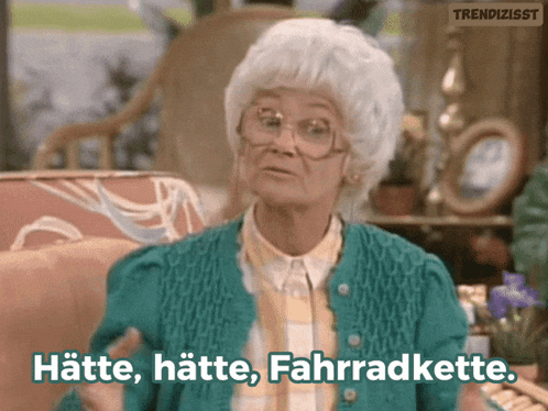 an elderly woman in a green sweater says hatte