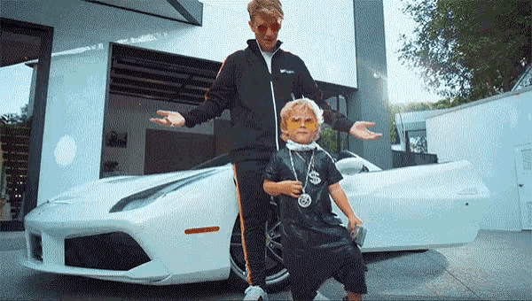 a man and a child are standing next to a white sports car .