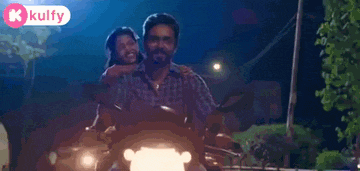 a man and a woman are riding on the back of a motorcycle .