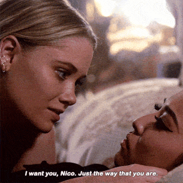 two women are laying on a bed and one of them says i want you nico just the way that you are