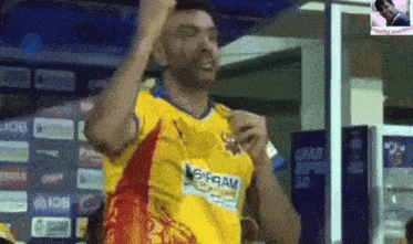 a man wearing a yellow and red shirt that says iob
