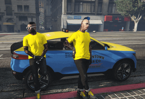 two men standing next to a blue car that says downtown b co