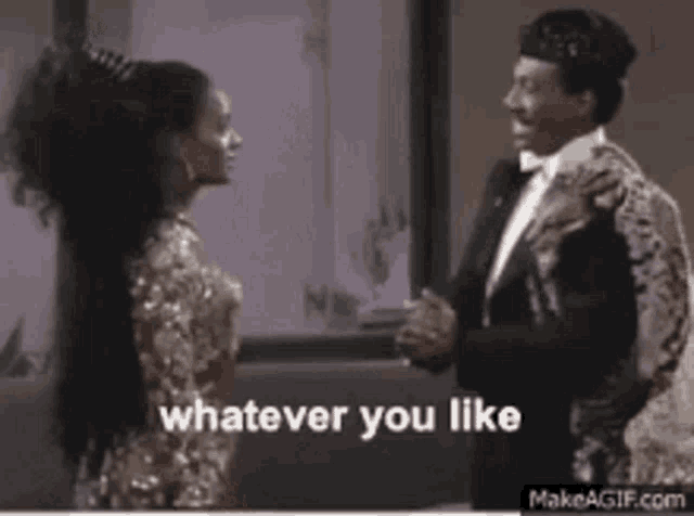 a man in a tuxedo and a woman in a dress are standing next to each other .