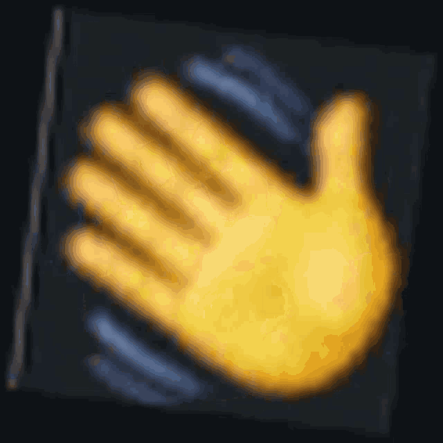 a blurred image of a yellow hand on a black background
