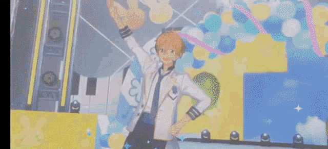 a man in a white jacket and tie is dancing on a stage with balloons in the background .