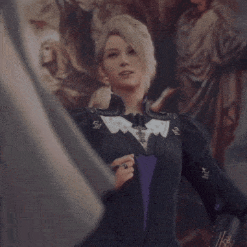 a woman in a black and purple outfit with a ring on her finger