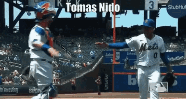 a mets baseball player named tomas nido is running towards a catcher