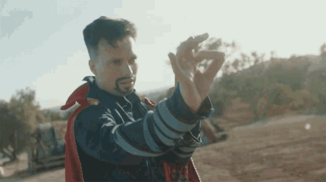 a man in a superhero costume is holding something in his hand