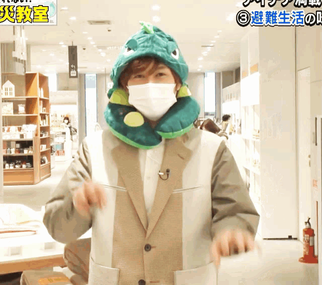 a man wearing a mask and a dinosaur hat is standing in a store
