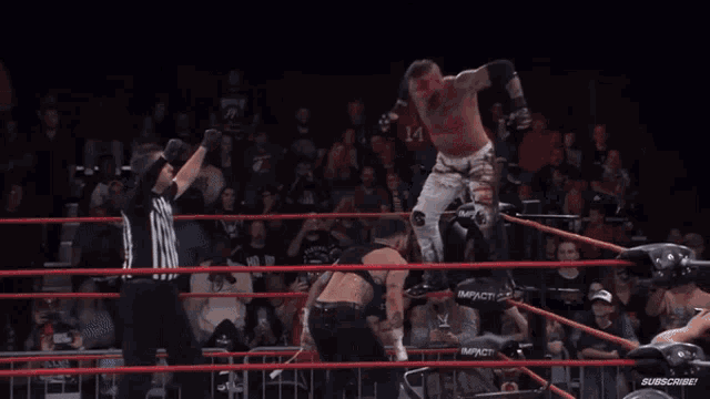 a wrestler is doing a flip in a wrestling ring while a crowd watches .