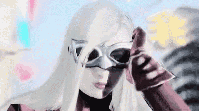 a woman wearing a mask is giving a thumbs up .